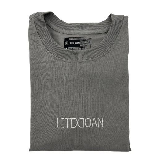 Folded gray t-shirt with 'LITDDOAN' text on a light gray background